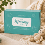 de mommy box omdoos op een wartm beige sprei